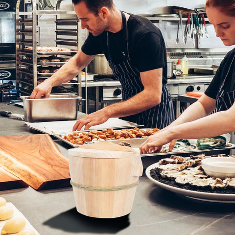 Kickin Flavor Infusion Starts With This Handmade Wooden Rice Steamer Bucket And Tight Fitting Lid Built On A Heavy Duty Stable Base Along With Heat Safe Handles For Daily Meal Prep, shown in a busy kitchen.