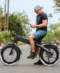 Cyclist on e-bike with 2 Pack Self Sealing Fat E Bike Tubes 20 By 4 Inch Puncture Resistant Inner Tubes With 32mm Schrader Valve Compatible With 20 By 3.5 To 4.0 Fat Bike Tires 89 102 406