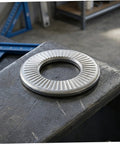 M6 Conical Knurled Spring Washer on metal surface, heavy duty 304 stainless steel for secure fastenings, high grip design.