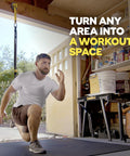 Man performing lunges in garage using Rock Solid Home Gym Wall Mount For Suspension Training Straps, Heavy Duty Steel Bracket.