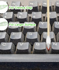 Cotton swab with bamboo stick, six-inch pointed tip, front view on a dusty keyboard for electronics cleaning