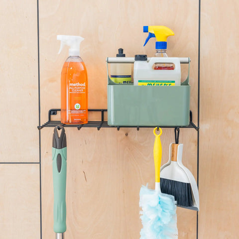 Legit Heavy Duty Wall Mounted Wire Shelf Rack With Nine Sturdy Hooks For Hauling Brooms Mops And Cleaning Gear holding cleaning bottles.