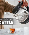 1.5L Borosilicate Glass Electric Kettle With Auto Shut Off, Boil Dry Protection pouring water into cup on countertop