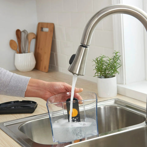 Filling a 12-cup coffee maker reservoir at a kitchen sink with Advanced Water Filter Cartridges For 12-Cup Programmable Coffee Makers.