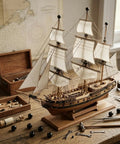Model ship with sails and tools on a wooden table, surrounded by 18Pcs M4 x 9mm Threaded Ball Knobs and Screw Caps Set for Lighting DIY Projects.