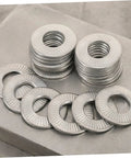 Built Different M6 Stainless Steel Belleville Washers 40 Piece Conical Spring Lock Plate Assembly stacked washers on a metal surface.
