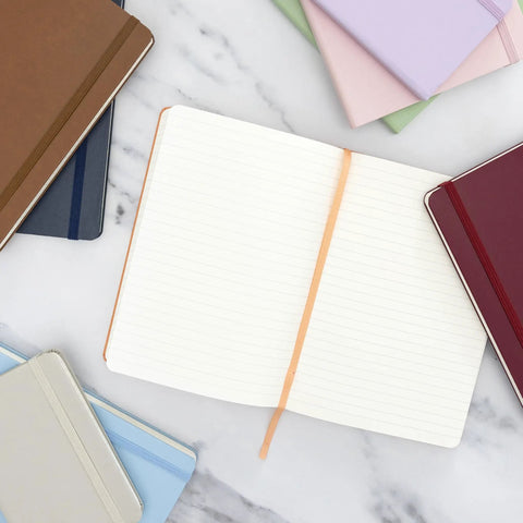 Top Shelf Hardcover Lined Journal Notebook With College Ruled Pages For Your Daily Grind And Heavy Note Taking on a marble surface.