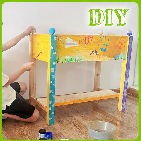 Child decorating raised wood planter box on legs with storage shelf for vegetables flowers and herbs, DIY natural finish.