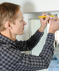 Man using a pencil to repair window shutters with Shutter Repair Kit with Replacement Pins and Staples for Easy Louver Movement Fixes Up Your Broken Window Covers No Sweat with Durable Plastic and Metal Hardware for Quick DIY Repairs that Really Hold Tight like a Charm.