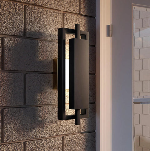 16 Inch Slick Matte Black Outdoor Wall Lantern With Integrated LED features a geometric design on a textured wall.