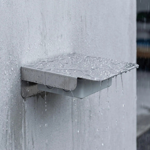 Rock Solid Stainless Steel EV Charger Protective Cover For Outdoor Charging Stations under rain, showcasing heavy-duty weatherproof design.