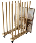 Rock Solid Beechwood Art Storage Rack With Locking Casters holds flat canvas boards and frames, showcasing a heavy-duty organizer.