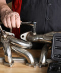 Man using Rethread Oxygen Sensor Tool And Thread Chaser For Clean Damaged Oxygen Sensor Threads M18 on exhaust manifold
