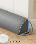 Heavy Duty Triangular Under Door Draft Stopper Works Like A Charm By Plugging Cold Drafts And Road Noise With A Weighted Core That Slides Right Into Place On Any Surface In Cool Gray, positioned by a door with accessories.