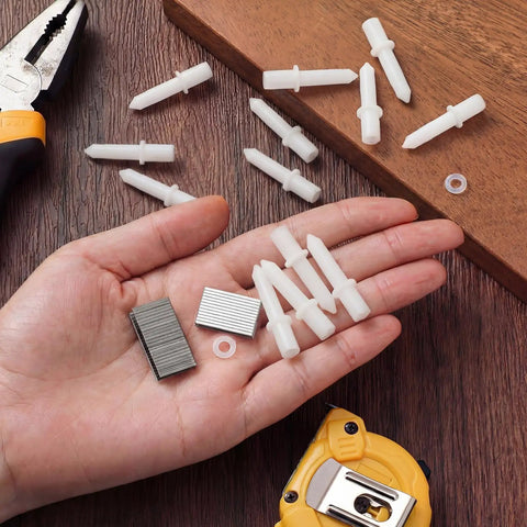 No Hassle Fixin Up Kit For Plantation Shutters featuring steel spring pins, louver staples, and collar pins in hand.