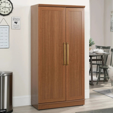 Antique brass cabinet pulls and drawer handles on wooden storage cabinet in modern kitchen interior.