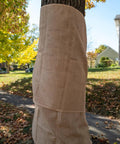 Heavy Duty Burlap Garden Fabric 12 Oz Odorless Food Grade For Weed Blocking And Erosion Control wrapped around a tree trunk.