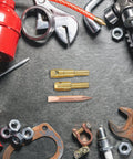 Spot Welder Chuck For Dent Removal Kit showing metal weld rod and pad surrounded by auto repair tools