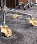 Heavy Duty Swivel Casters Four Pack Brass Furniture Wheels Silent Roll Protects Hardwood Floors Built Tough For Tables And Chairs Smooth Glide Rolling Hardware installed on a chair base.