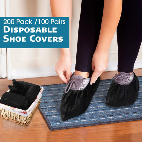 Person wearing 200 Pack Disposable Shoe Covers Non Slip Waterproof Non Woven Fabric Black Booties For Indoor Outdoor Use Extra Large 100 Pairs