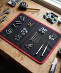 Foldable Magnetic Tool Mat With 40 Lbs Hold, Flexible Parts Organizer For Auto Repair And Electronics, Ultra Strong Magnetic Hold Keeps Screws Wrenches Bolts Secure Even On Tilted Or Vibrating Surfaces, black with red edge on workbench