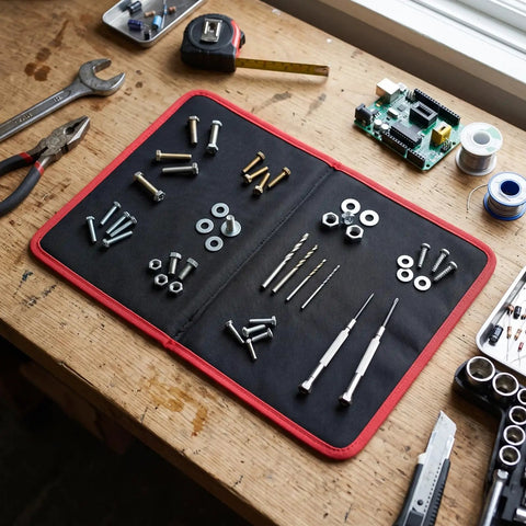 Foldable Magnetic Tool Mat With 40 Lbs Hold, Flexible Parts Organizer For Auto Repair And Electronics, Ultra Strong Magnetic Hold Keeps Screws Wrenches Bolts Secure Even On Tilted Or Vibrating Surfaces, black with red edge on workbench