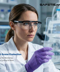 Tough As Nails Clear Safety Glasses Heavy Duty Bulk Pack Featuring Adjustable Temples And Side Shields Ansi Z87 Rated Impact Proof Protective Eyewear For Job Site And Lab Setup being worn by a woman in a lab.