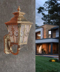 Rustic Exterior Wall Lantern Heavy Duty Outdoor Light Fixture For Front Porch Durable All Weather Barn Style Sconce With Solid Antique Brown Finish mounted on a textured wall.