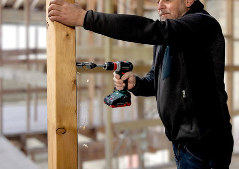 Badass 18 Volt Cordless Brushless Drill Driver Delivering 60 Newton Meters Of Torque And A Featherweight 2 Pound Build operating on wood.