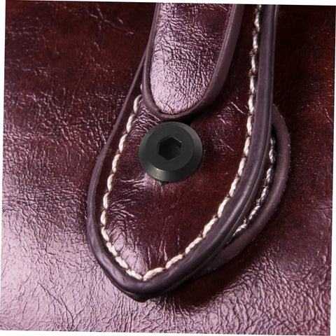 Tough As Nails M6x25 Stainless Steel Binding Post Screws For Leather Bags And Saddle Work showing close-up of black socket cap fastener on leather.