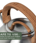 Stovetop Whistling Tea Kettle Two Point Four Quart Stainless Steel For Induction And Gas Stovetops with wooden handle close-up