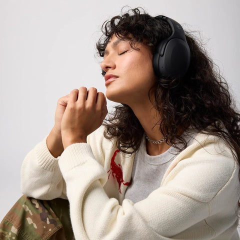 Person wearing Crusher Evo Wireless Bluetooth Headphones with Dope Multi Sensory Bass, noise isolating over-ear fit.