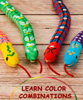 Colorfully painted wooden snakes from the Ten Piece Unfinished Wooden Snakes Craft Kit With Jointed Wiggly Bodies displayed on wood surface.