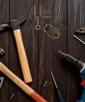 Two Pack Bear Shaped Iron Hasp Latch Lock Set For Tool Boxes And Small Chests on wooden surface with tools around