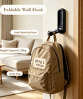 Tough As Nails Zinc Alloy Folding Wall Hooks Space Saver Flip Down Design For Coats Bags Hats And Keys Zero Clutter Vibe Six Pack With Gold White Black Options Built To Last Big Time. Black foldable wall hook supporting large backpack, with weight capacity of 20kg.