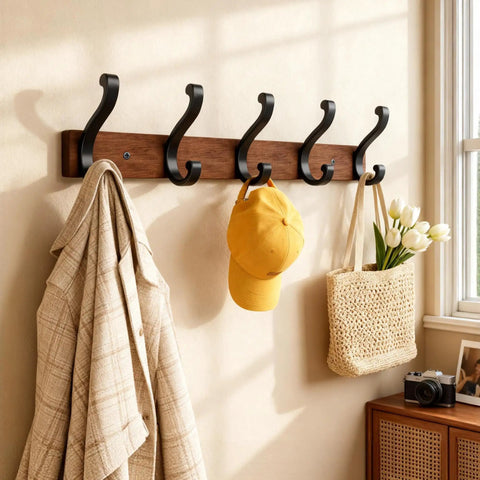 Solid Wood Wall Mounted Coat Rack With Five Heavy Duty Metal Hooks Holds Up To 25 Lbs Each For Hats Coats Towels Backpacks And Keys In The Closet Entryway Bedroom Or Bathroom 2 Pack displaying various items hanging in a sunlit room.