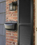 Black Wall Mount Mailbox Crafted From Die Cast Aluminum With Powder Coat installed on brick wall beside front door