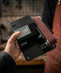Compact Mini Electric Belt Sander For Home Knife Sharpening Slick Polish Workflow Lightweight Belt Grinder held in hand.