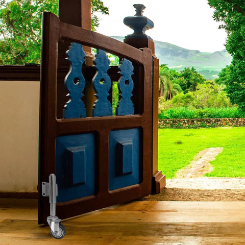 Heavy Duty 3 Inch Swivel Gate Support Wheel Beater Free Steel Caster for yard fence gate, mounted on a wooden gate.