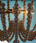 Close-up of Boho Beaded Flush Mount Light 3 Light Ceiling Fixture With Gray Wood Beads And Golden Bronze Finish 16 Inch Diameter