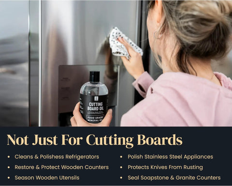 Person polishing stainless steel fridge with Food Grade Mineral Oil For Wood Cutting Boards And Butcher Blocks 16oz Safe For Bamboo Marble Soapstone And Stainless Steel Counters Made In USA Top Notch Kitchen Care And Conditioning For Long Lasting Finish