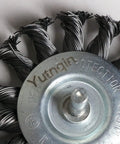 Close-up of Three Piece Knotted Wire Wheel Brush Set For Drill With One Quarter Inch Shank showing twisted metal wires