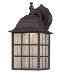 Solid Exterior Wall Lantern Featuring Slick Weathered Patina Cast Aluminum Body Plus Crisp Seeded Glass Panes mounted on wall.