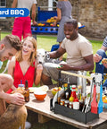 Outdoor BBQ scene with Grill Caddy With Dual Paper Towel Holders, condiments, and utensils on picnic table, surrounded by people