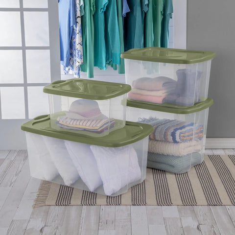 120 Qt Big Boy Storage Bin, Clear Plastic Tote With Green Lid, stacked with blankets and clothing, heavy duty handles, ideal for dorm and closet organization.
