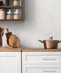 Modern kitchen with copper pot and Ten Pack Six And A Quarter Inch Square Kitchen Cabinet Handles in Satin Nickel Finish on white cupboards.