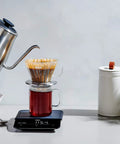 Gooseneck Electric Kettle For Pour Over Coffee And Tea With Dialed In Temperature In One Degree Increments From 104 To 212 Fahrenheit And 40 To 100 Celsius Built In Brew Timer Stainless Steel 1 Liter, showcased pouring water into coffee dripper on scale.