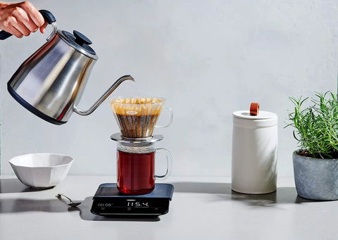Gooseneck Electric Kettle For Pour Over Coffee And Tea With Dialed In Temperature In One Degree Increments From 104 To 212 Fahrenheit And 40 To 100 Celsius Built In Brew Timer Stainless Steel 1 Liter, showcased pouring water into coffee dripper on scale.