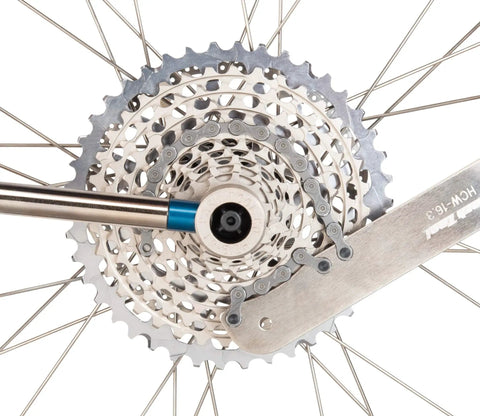 All In One Chain Whip And Pedal Wrench For Bike Maintenance, 10.75 Inch Steel Tool, shown on bike cassette, silver finish