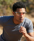 Man wearing Badass Silicone Safety Glasses For Construction Work, shatterproof polycarbonate lenses, while running outdoors.